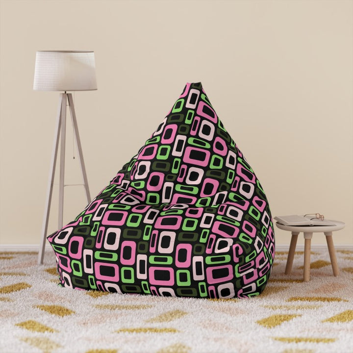 Geometric lounger cover in pop art pink and green shapes on black